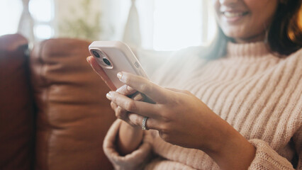 Home, hands and woman with smartphone, relax or playing video game in living room, happy and...