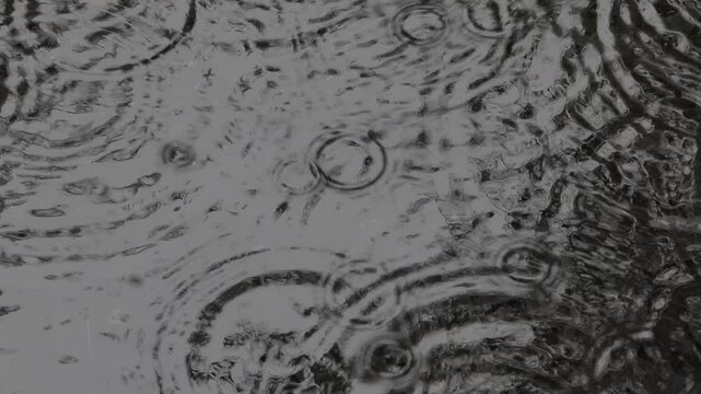 Tokyo, Japan - June 23, 2025: Slow-motion of rain falling on a pool