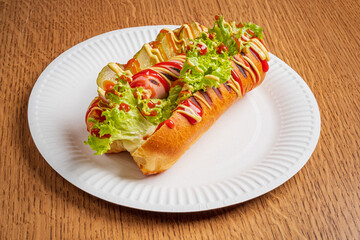 Savory hot dog filled with crisp lettuce, tomatoes, and drizzled with ketchup and mayo