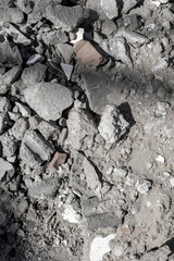 Close-up of gray concrete rubble with broken tile pieces and debris