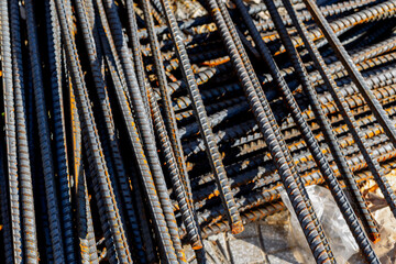 Rusty steel rebar stacked in construction site for foundation reinforcement
