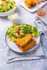 Fried potato pocked filled with cream cheese and herbs with mixed salad