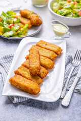 Fried potato pocked filled with cream cheese and herbs with mixed salad