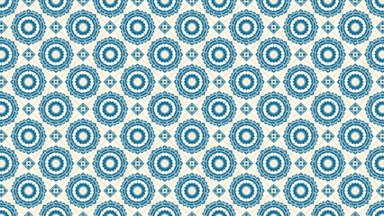 Repeating pattern of blue floral circles and diamonds on a light beige background in a symmetrical design