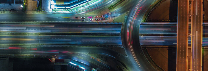 Aerial view of car traffic transportation above intersection road of Drone aerial view fly , high angle. Public transport or commuter city life concept of economic and energy, infrastructure	