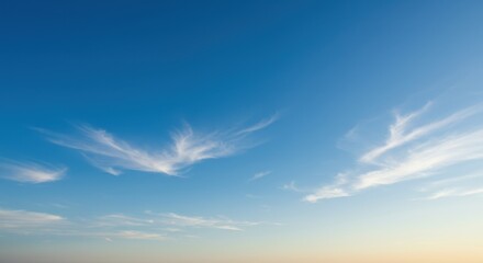 Fototapeta premium Serene Sunset Sky: Wispy Clouds in a Blue Heaven