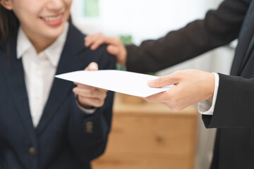 Good job Asian manager businesswoman giving financial reward in an envelope, business letter extra...