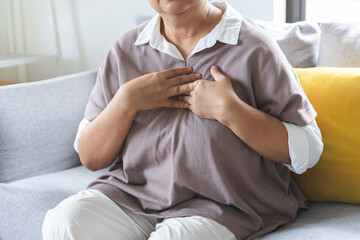 Chest pain, attack chest, emergency heartbeat asian senior woman holding hand on chest, suffering...