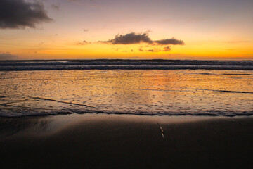 Sunset on the ocean with little waves.