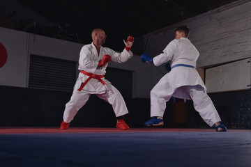 Teenage Boy Practicing Karate with His Father and Instructor