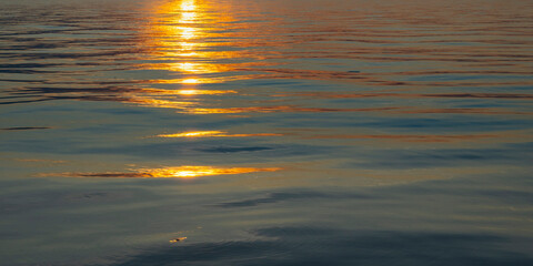 reflections from sunset on the lake of Constance, beautiful colored waves with Reflections on the...