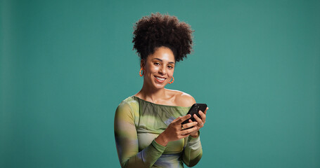Phone, smile and portrait of woman in studio for social media, message or fashion blog. Mobile,...