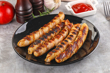 Grilled meat sausages wrapped bacon