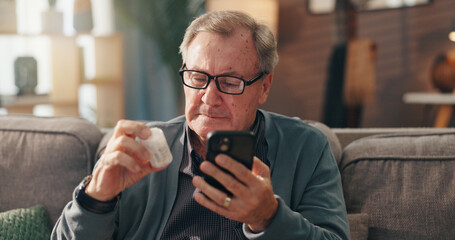 Senior man, phone and reading medication on sofa for side effects or pharmaceutical instructions. Elderly, male person or patient with pills on mobile smartphone for research or prescription at home