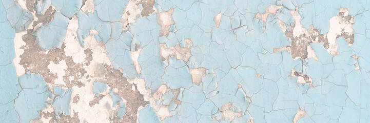 Fototapeta premium Peeling paint on the wall. Old concrete wall with cracked flaking paint. Weathered rough painted surface with patterns of cracks and peeling. Grunge texture for background and design. High resolution.