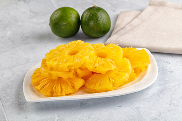 Sweet canned pineapple slices in syrope