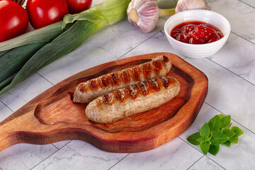 Grilled pork sausages served tomato sauce