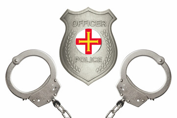 Guernsey police officer badge with steel handcuffs isolated white background