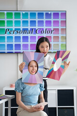 Asian stylist conducts a color type procedure for a young woman.personal consultation about...