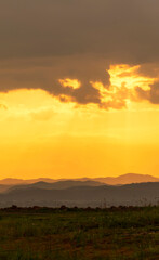 Obraz premium Vertical Horizon Sunset mountain range beautiful landscape mist foggy sunrise beam. Golden sky Mountain landscape mountain. Vertical Amazing Landscape cloud sky on sunrise. Gold sunlight heaven scene