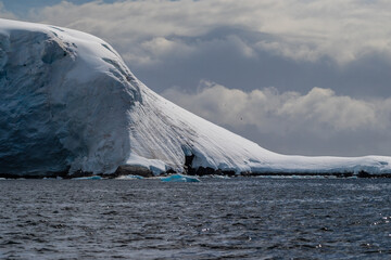 A tranquil Antarctic landscape, near Graham passage along Charlotte Bay, highlighting stark...