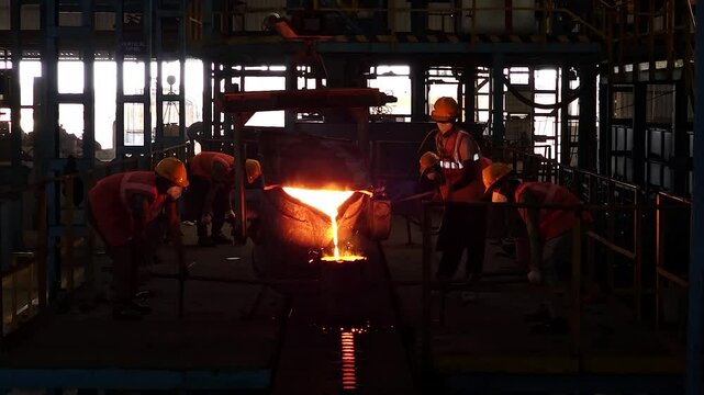 Rajkot, Gujarat, India 03 26 2025: workers are filling molten metal in casting components with casting furnace 
