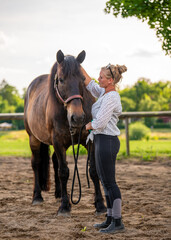 Rustic village scene with young woman caressing horse in corral. Calm and heartfelt moment capturing rural lifestyle, animal affection, and harmony with nature.