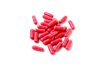 Red astaxanthin supplement capsules on a white background.