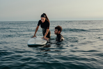 Woman learning how to surf on her summer vacation