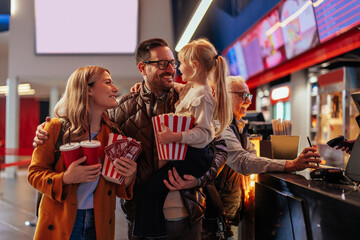 Joyful family in cinema hall.