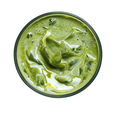 Overhead shot of a matcha latte in a glass cup with visible white swirls on a black background on transparent background