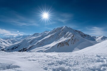 Fototapeta premium Snowcapped mountains against a blue sky with the sun shining brightly overhead