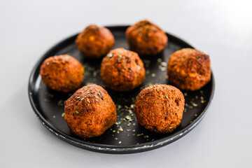 homemade chickpea falafels with paprika cumin and coriander on black plate