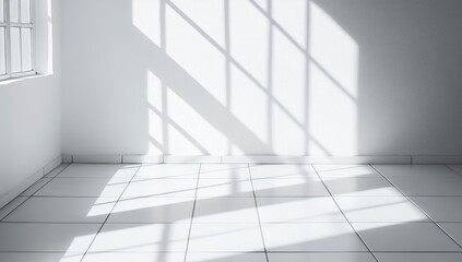 Obraz premium Sunlight streams through a window, casting dramatic shadows on a white room