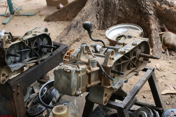The ATV engine is disassembled for repair at the engine repair center in the business. ATV engine parts, three-speed automatic system.
