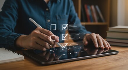 Digital checklist: Hands using a stylus on a tablet, ticking boxes over a wooden desk.