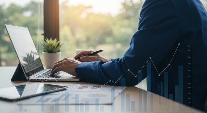 Financial Growth: Businessman at Laptop Analyzing Data with Chart Overlay