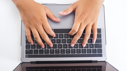 Top view of hands of a businessman typing on laptop keyboard isolated on white background