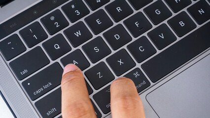Full frame of finger pressing command and A letter button or cmd + A  on a laptop keyboard,...