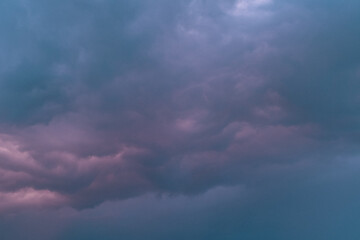 Dramatic thunderstorm with dark clouds in the evening. Dramatic cloudscape featuring dark, moody...
