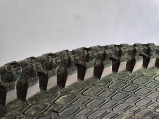Close-Up of Worn Bicycle Tire Tread with Aggressive Hexagonal Pattern and Dirt Residue