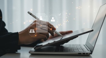 Digital workflow: Hand using stylus on tablet, laptop, and user interface elements, soft focus.