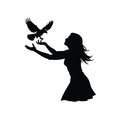 Silhouette of a woman releasing a bird into the air with hope