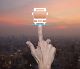 Hand pressing bus flat icon over blur of cityscape on warm light sundown, Business transportation...