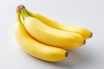 Four ripe yellow bananas, slightly curved, clustered together on a plain white background