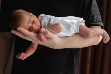 Newborn Baby Cradled in Hand