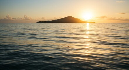 Obraz premium Serene island scenery reflecting warm sunlight on tranquil ocean water at sunset