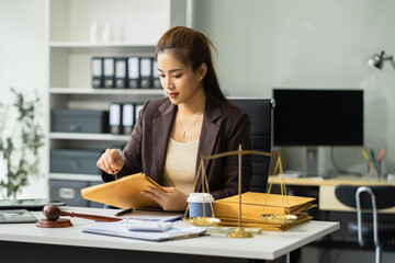 Business woman and lawyers discussing contract papers sitting in the table at office.