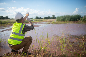 An environmental engineer examines water samples from a natural to identify organisms in ecosystem