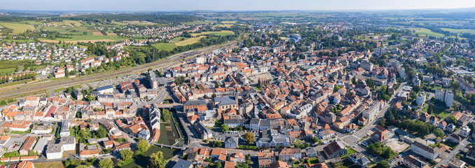 An Aerial panorama view with pan of the old town around the city Sarrebourg in France on a sunny...